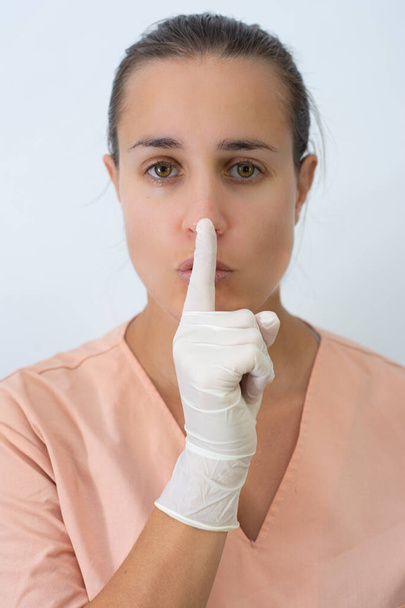 Doctor woman asking for silence with latex gloves - Foto, Imagem