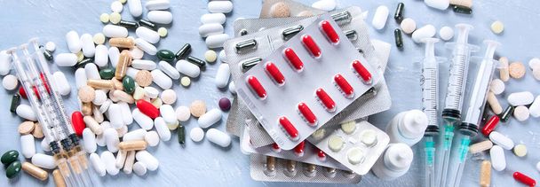 Heap of various Pharmaceutical medicine pills, tablets and capsules. Medical concept. Top view, panorama,banner - 写真・画像