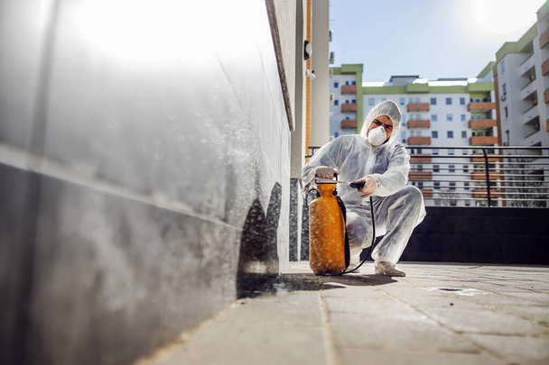 Cleaning and Disinfection outside around buildings, the coronavirus epidemic. Professional teams for disinfection efforts. Infection prevention and control of epidemic. Protective suit and mask. Professional specialist full protective cleaning outsid - Photo, Image