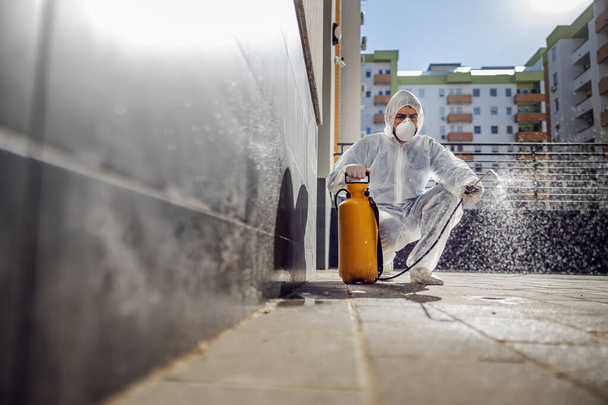 Cleaning and Disinfection outside around buildings, the coronavirus epidemic. Professional teams for disinfection efforts. Infection prevention and control of epidemic. Protective suit and mask. Professional specialist full protective cleaning outsid - Photo, Image