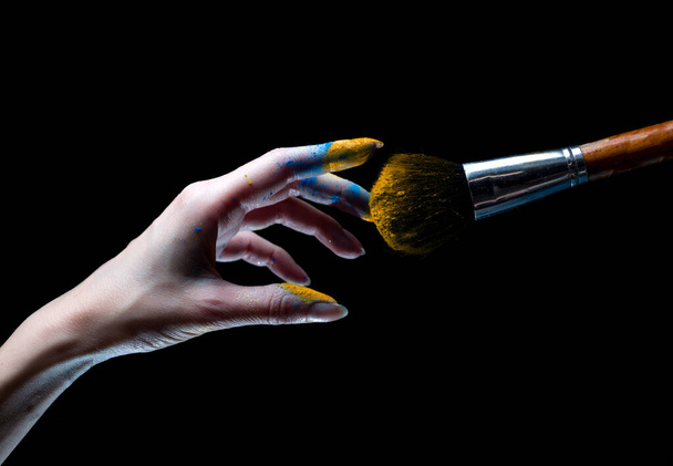 hand and brush for makeup in powder in the paint is very beautiful - Photo, Image