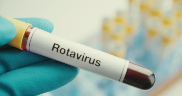 Close-up scientist hands gloves laboratory test tube protection Rotavirus positive background - Filmagem, Vídeo