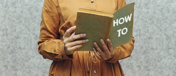 closeup γυναίκα κρατώντας ένα βιβλίο με το πώς να εννοήσει  - Φωτογραφία, εικόνα