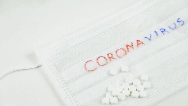 Pandemic. White medicine masj with white pills. Stop coronavirus - Photo, image