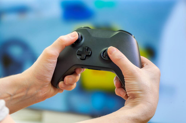 Hands holding console controller.Playing video games concept - Photo, Image