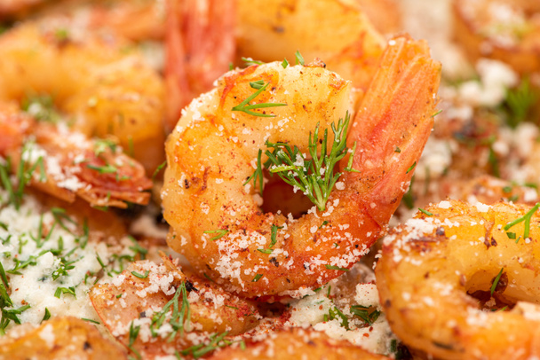 close up view of fried shrimps with dill and grated cheese - Foto, Imagen