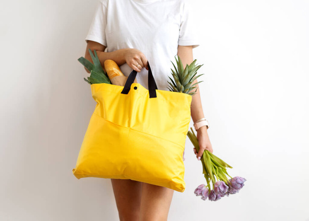 girl holding a bag with products with takeaway food. Food delivery - Photo, image