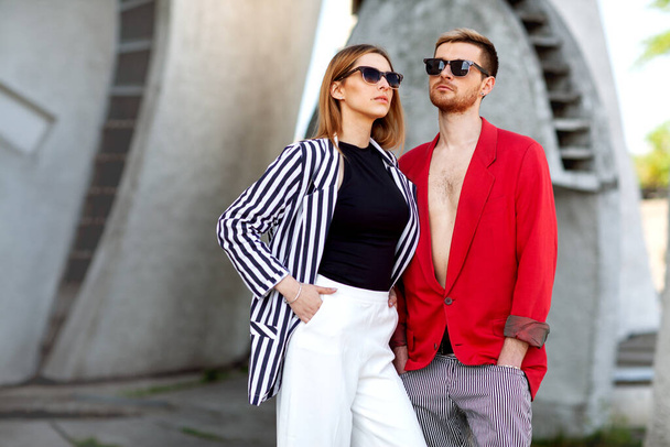   Fashion girl and guy in outlet clothes posing on a white background - Fotografie, Obrázek