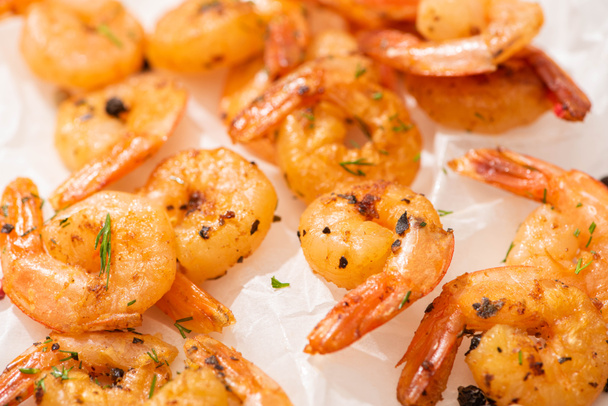 close up view of fried shrimps on white parchment paper - Photo, Image