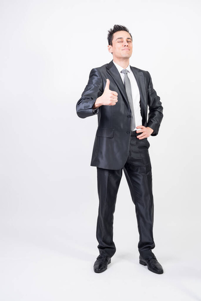 Satisfied man in suit. White background, full body - Foto, Imagen