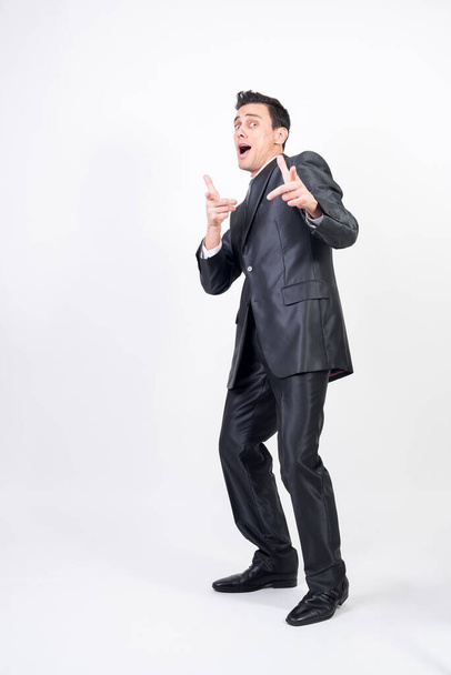 Satisfied man in suit. White background, full body - Foto, afbeelding