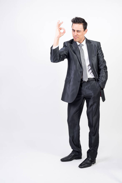 Satisfied man in suit. White background, full body - Photo, Image