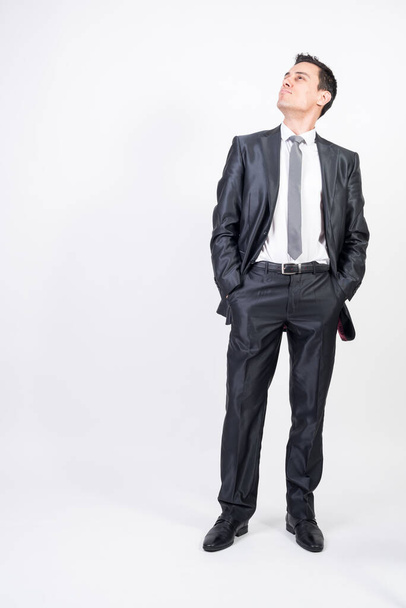 Optimistic man in suit. White background, full body - Foto, afbeelding