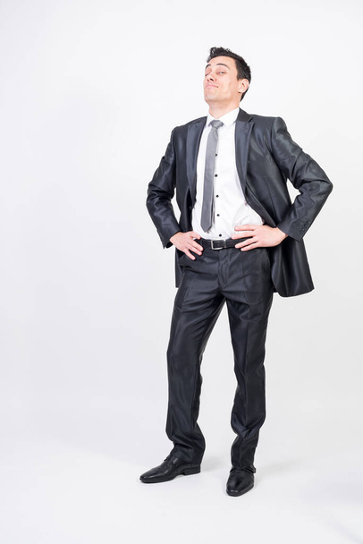 Optimistic man in suit. White background, full body - Fotó, kép