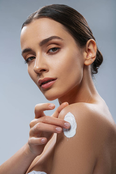 Young woman using cosmetics for body stock photo - Photo, image