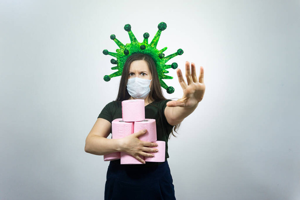 Coronavirus COVID-19 hysteria with toilet paper. Woman in a protective mask. Concept on the topic of coronavirus. - Fotografie, Obrázek