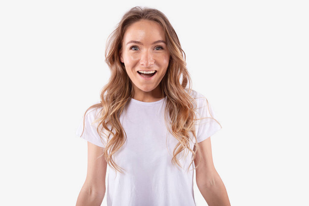 Young caucasian woman pleasantly surprised, joyfully smile. Amazing luck concept - Photo, image