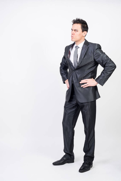 Man in suit scolding someone. White background, full body - Foto, imagen