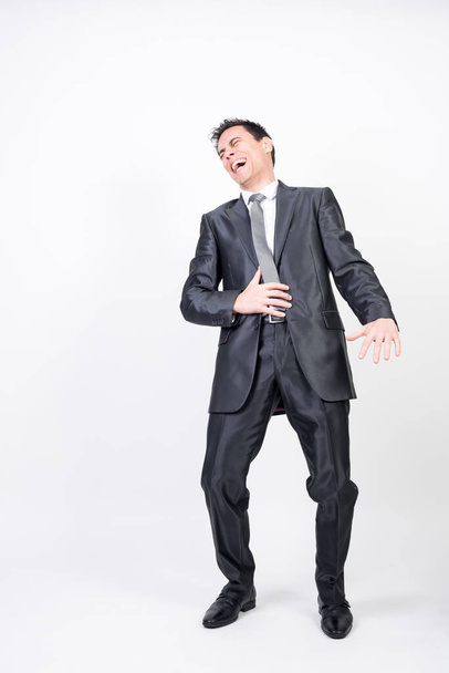 Laughing man in suit. White background, full body - Photo, Image