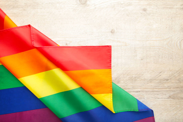 Rainbow LGBT flag on grey wooden background, top view - Foto, Imagen