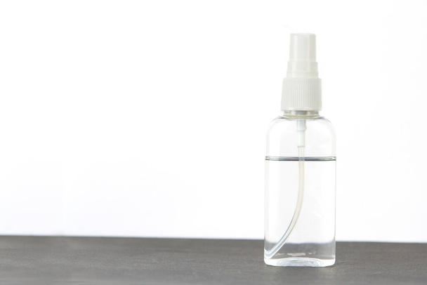 Coronavirus hand sanitizer spray for hand hygiene for corona virus protection on the table on white background. - Foto, afbeelding