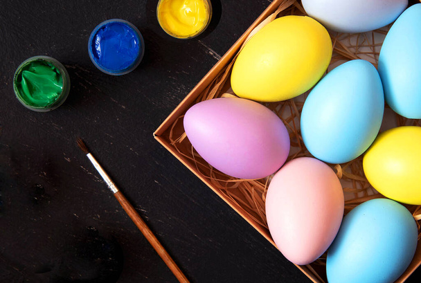 Preparation for coloring Easter eggs on black background. - Photo, Image