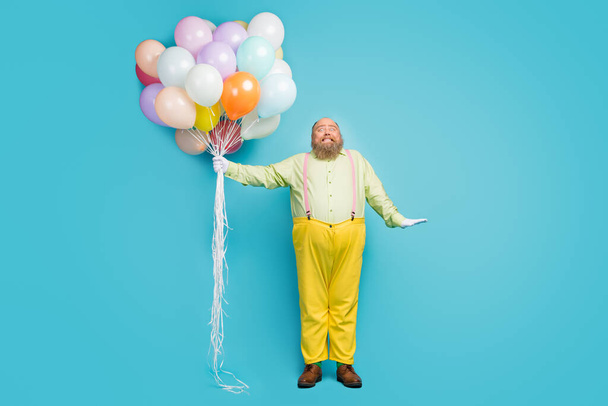 Full length body size view of his he nice attractive childish cheerful bearded mature guy holding in hand bunch air balls having fun isolated over bright vivid shine vibrant blue color background - Φωτογραφία, εικόνα