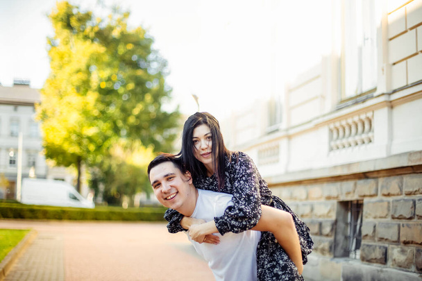 Beautiful young couple having fun outside on a summer day. - Fotó, kép
