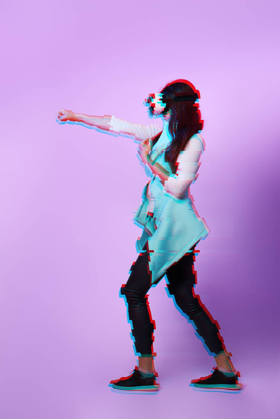 Woman is using virtual reality headset. Image with glitch effect. - Foto, imagen