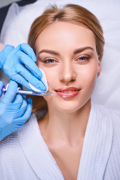 Happy woman during beauty injections stock photo - Fotografie, Obrázek