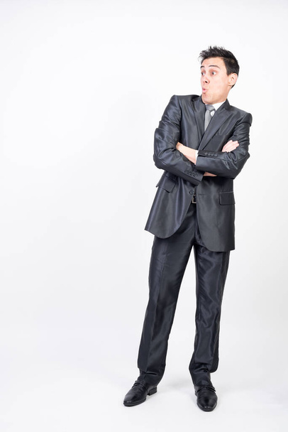 Surprised man in suit. White background, full body - Foto, afbeelding