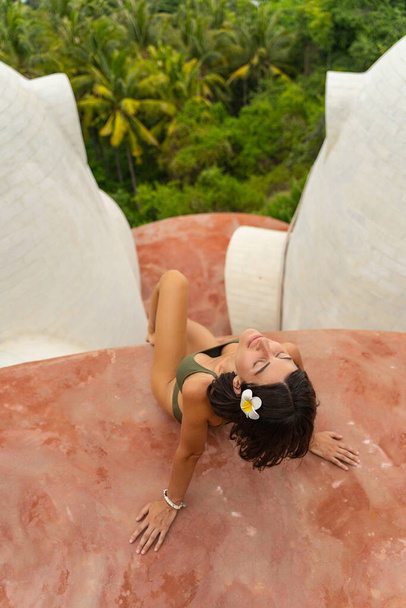 Slim young lady in a bikini dozing outdoors - Foto, Bild