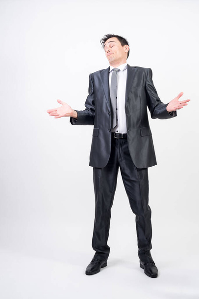 Self-confident man in suit. White background, full body - Photo, Image