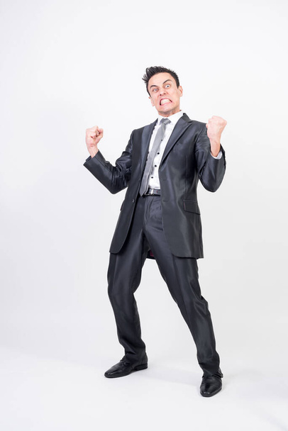 Hysterical man in suit. White background, full body - Foto, afbeelding