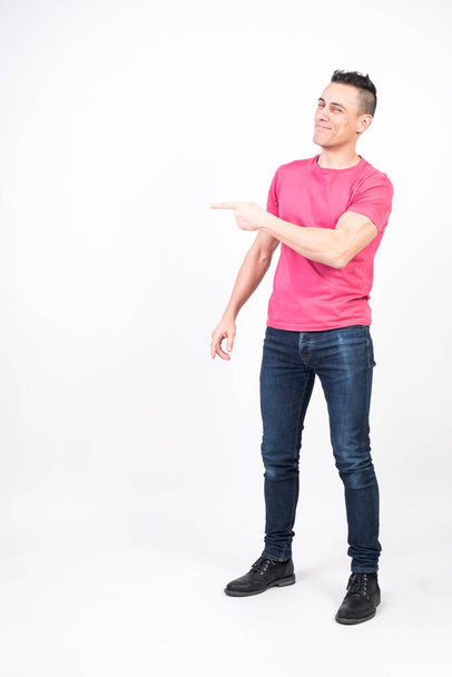 Smiling man pointing to copy space. White background, full body - Foto, Imagem