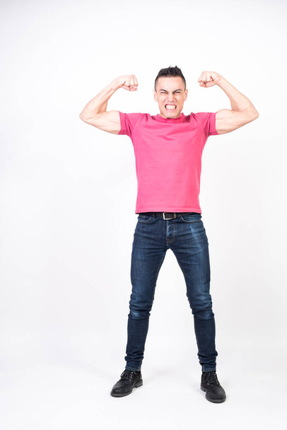 Man pulling out biceps. white background, full body - Photo, Image