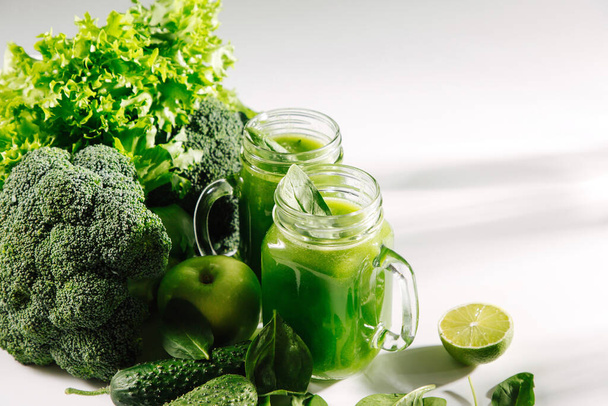 Fresh blended green smoothie in  jar on white table. Detox and diet  concept. Vegetarian food. - Foto, Imagem