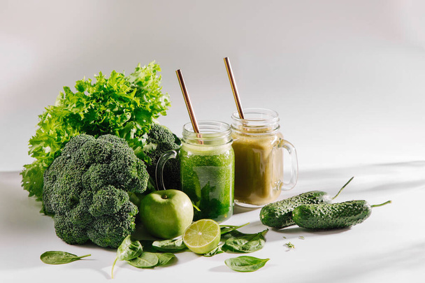 Fresh blended green smoothie in  jar on white table. Detox and diet  concept. Vegetarian food. - Φωτογραφία, εικόνα
