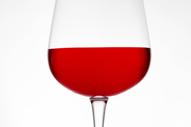Deep red wine glass in closeup with white background - Zdjęcie, obraz