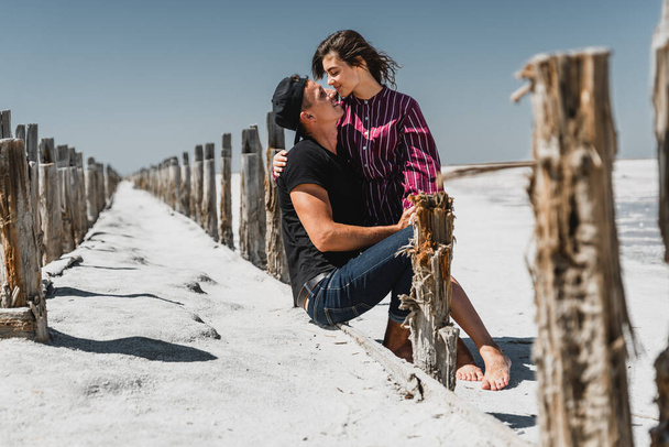 love story in the desert, happy young couple,young people are walking and holding hands,love story in a beautiful place,summer vacation for a young couple,beautifully dressed young people in love - Фото, зображення