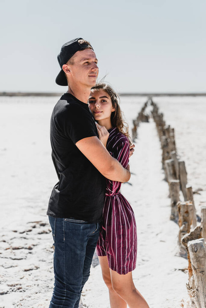 love story in the desert, happy young couple,young people are walking and holding hands,love story in a beautiful place,summer vacation for a young couple,beautifully dressed young people in love - Photo, Image