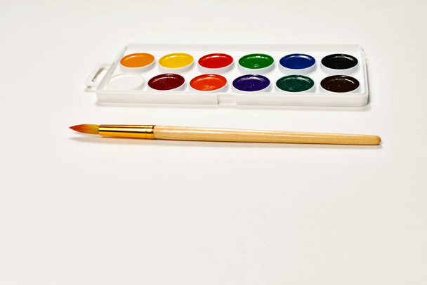 Watercolor paints and brush for drawing. Childrens creativity, painting, early development. - Photo, Image