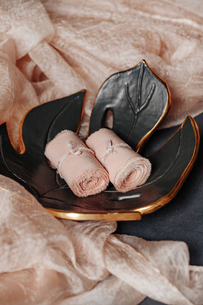 Special silk ribbon on leaf shape plate with fabric cloth made of wool. Perfect props for table decoration. A decorative light peach color motif for wedding and other event. - 写真・画像