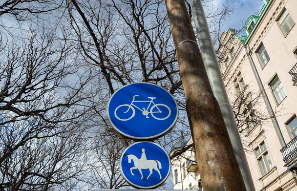Blue road signs a road for cyclists and a road for riders on a street in Stockholm. - Φωτογραφία, εικόνα