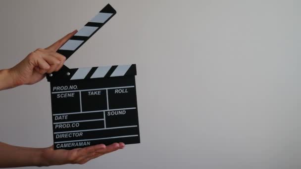 Female holding wooden clapperboard. Cinematography production concept. Copy space advertising mock up.  - Footage, Video