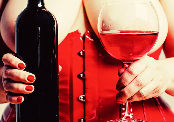 Red wine in bra between boobs. Woman Plus Size posing with glass of wine. XXL big size. Beautiful girl shows her gorgeous Breasts. wine list for the restaurant menu. Woman in red holding wine glass. - Photo, image