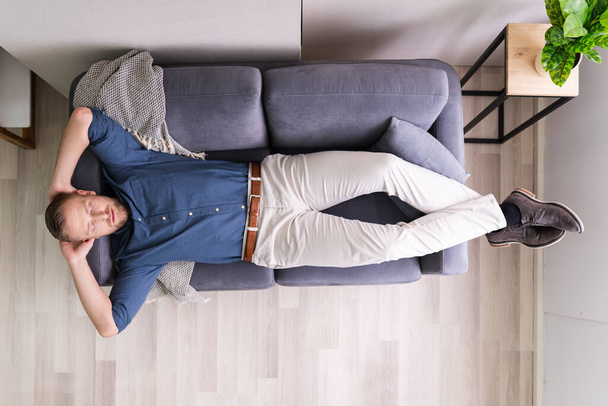 Portrait Of Tired Man Sleeping On Couch - Fotoğraf, Görsel