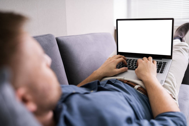 Cropped Image Of Young Man Using Laptop At Home - Foto, immagini