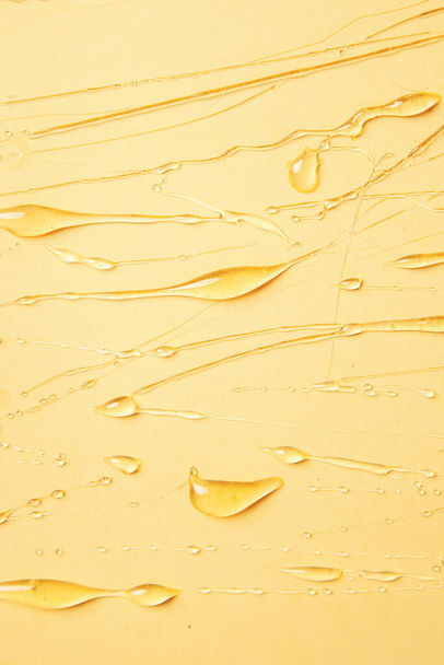 Background of melting honey on a yellow background, spreading honey place for text, drops, texture - 写真・画像