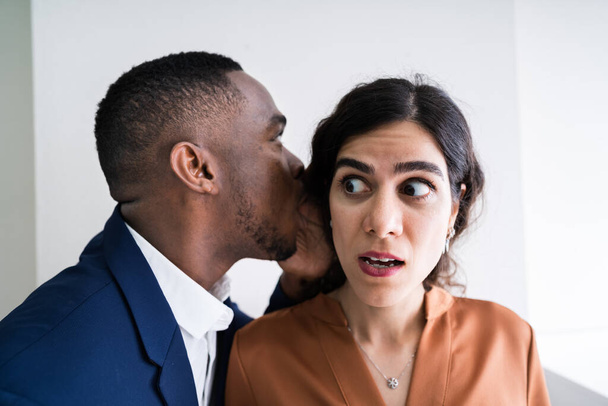 Close-up Of Businessman Whispering Into Female Partner's Ear - Foto, Bild